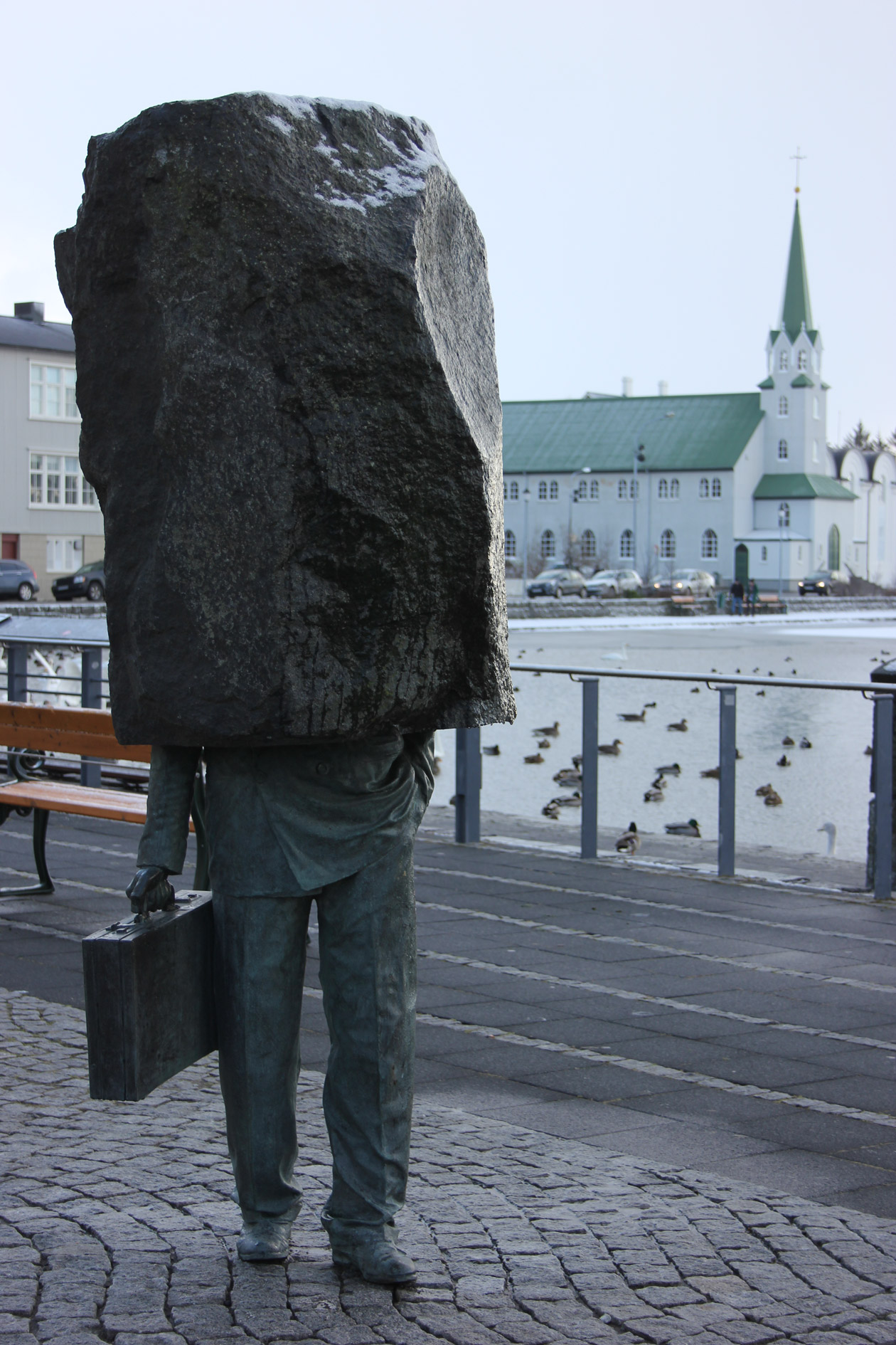 A sculpture beside the Reykjavíkurtjörnin lake with the Free Church in the background