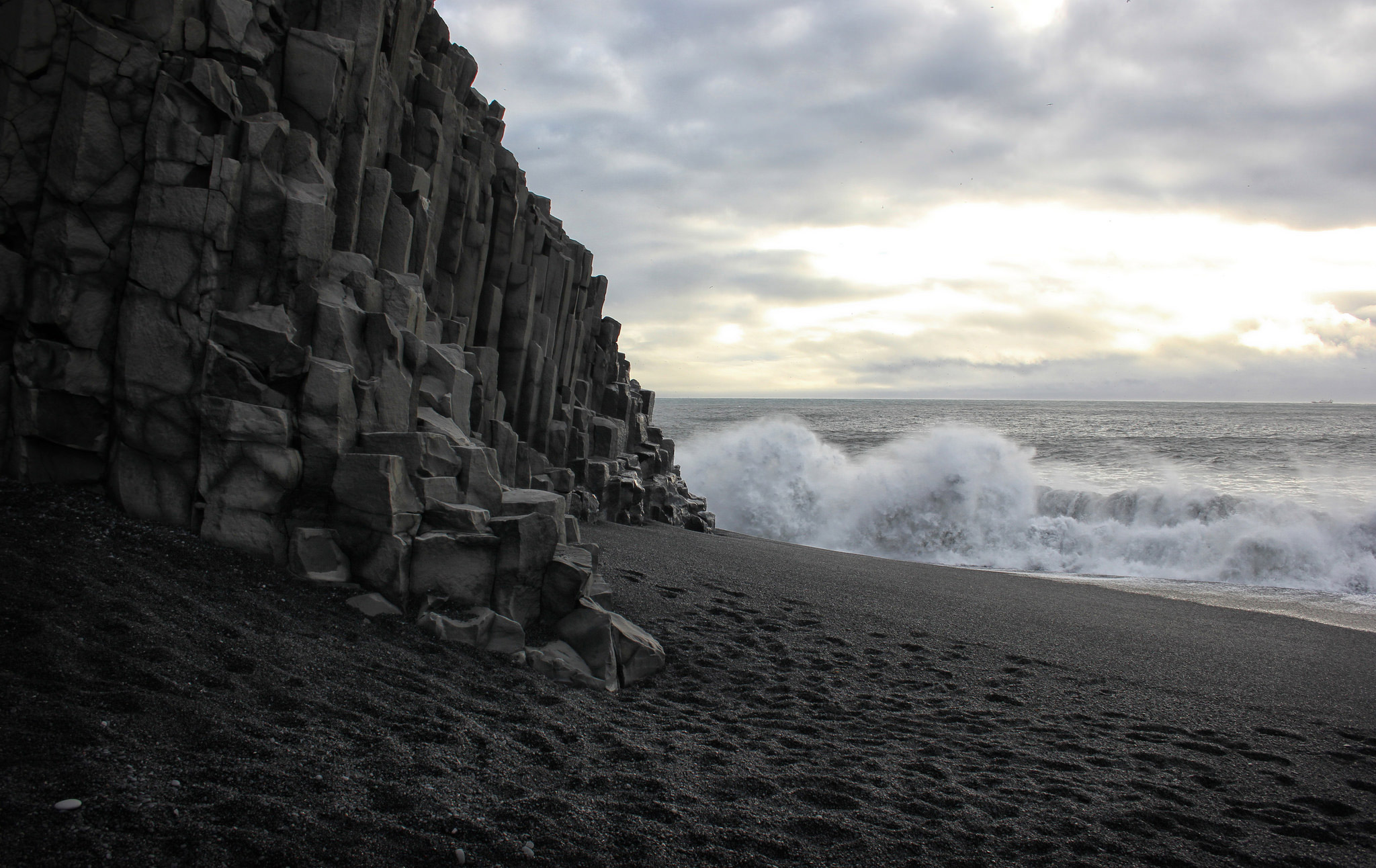 The waves crashing against the basalt cliffs at Vik