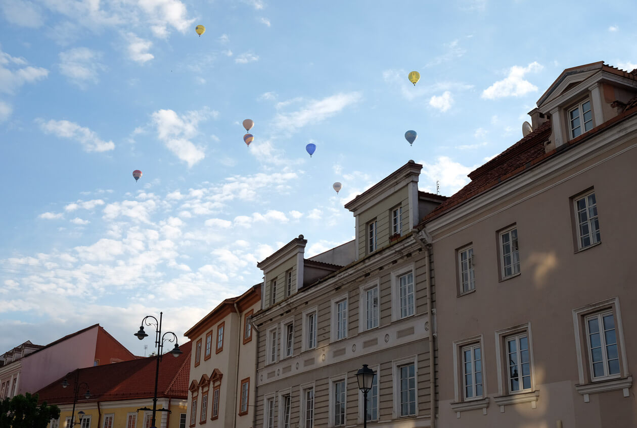 Hot air balloons gliding over Vilnius's old town
