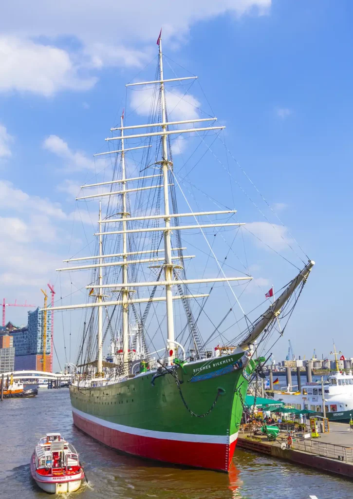 The Rickmer Rickmers historic ship in Hamburg. A large sailing ship with tall masts and a green hull sits on the Elbe River.