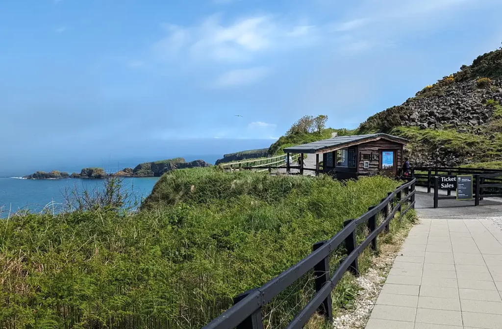 A wooden hut at the start of a cliff path above the sea