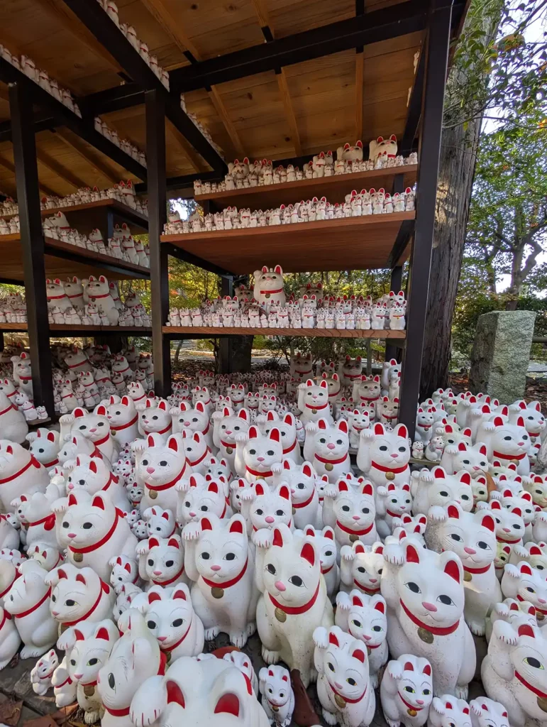 Hundreds of lucky cat figures on shelves at Gōtokuji Temple, Tokyo