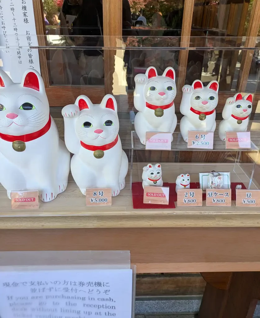 Lucky cat ceramic figures in different sizes with prices. Some are marked as sold out.