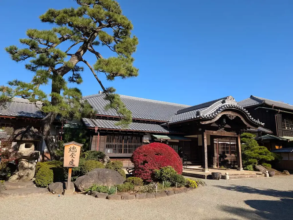 Temple buildings, with autumn leaves on the trees and bushes in the garden