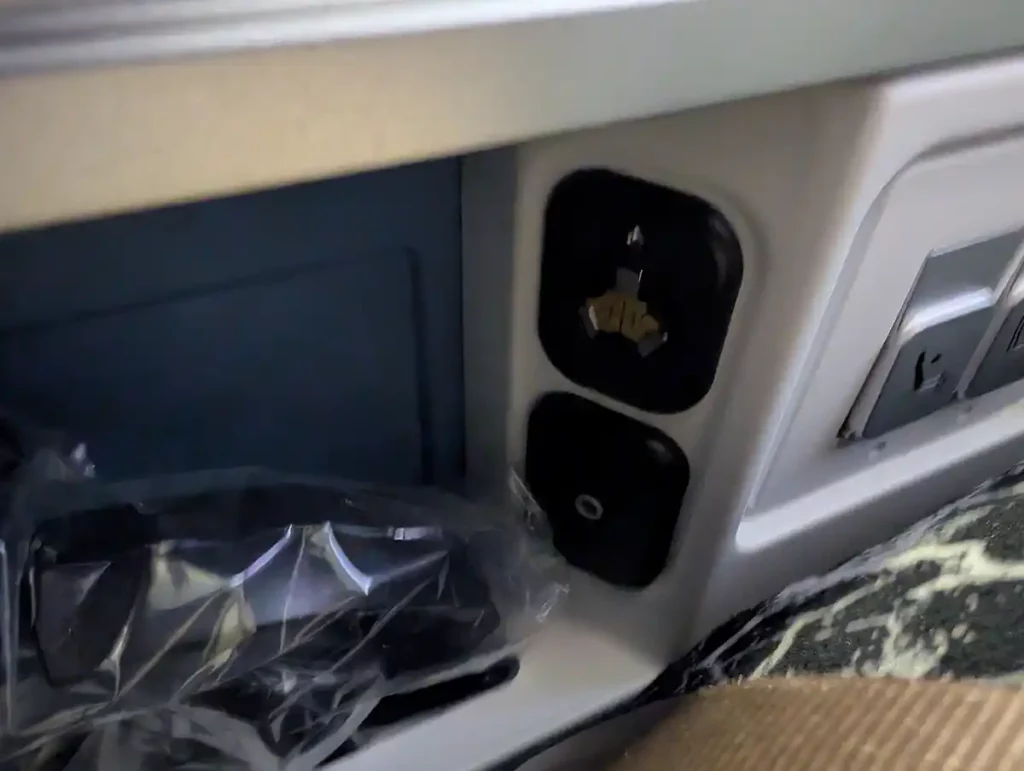 A blurry photo of the headphone connectors in the armrest