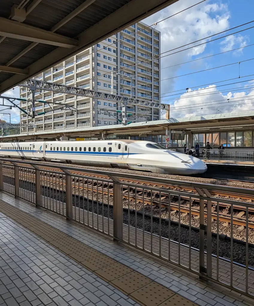 A white Shinkansen train at Odawara station