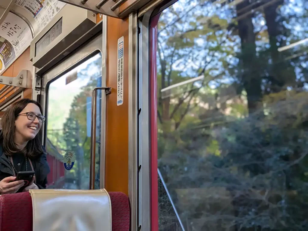 A woman looking delighted as she looks out of a train window