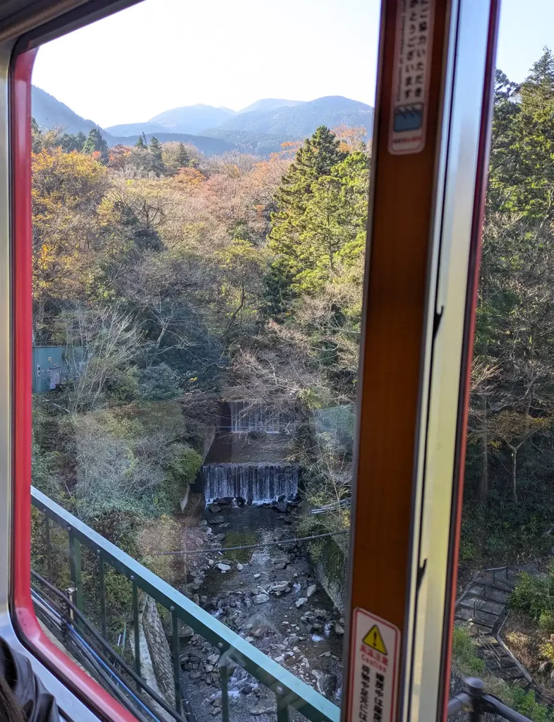 Looking through a train window at a waterfall below