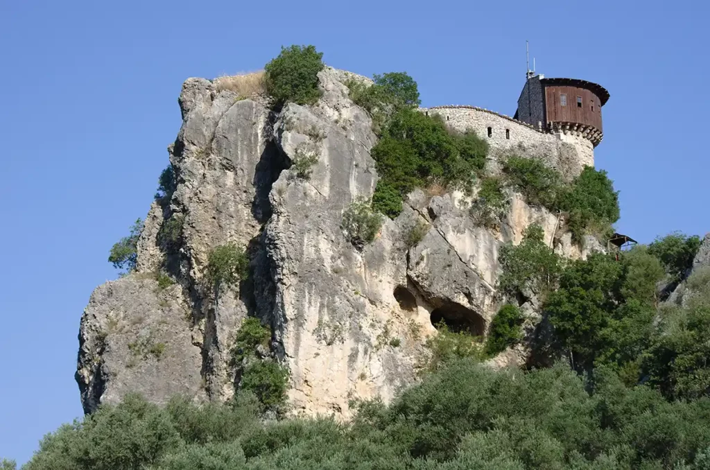 A wooden castle on top of a dramatic rock